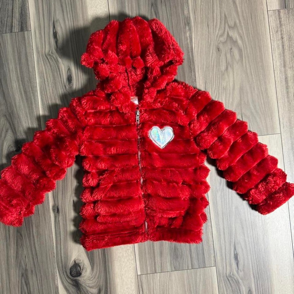 Adorable red faux fur jacket with a cute white heart patch detail